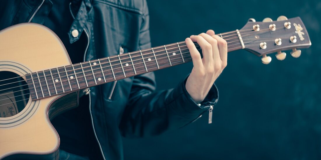 Akustikgitarre und ein Gitarrist
